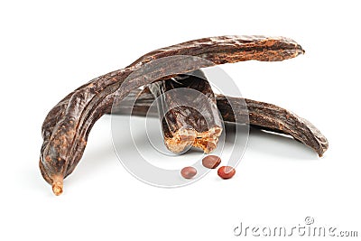 Carob carob fruit and seeds on white background. Isolate. Organic carob beans, a healthy alternative to cocoa Stock Photo