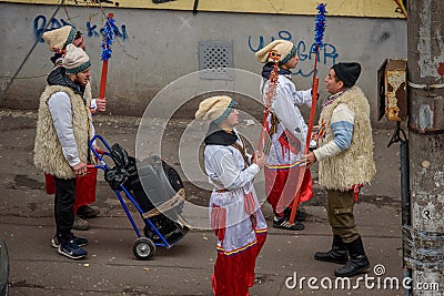 Carolers in traditional costumes walking on the street from Bucharest Editorial Stock Photo