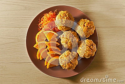 Carotte muffins served on the plate with orange slices Stock Photo