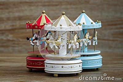 Carousel Music Boxes on Brown Wooden Background Stock Photo