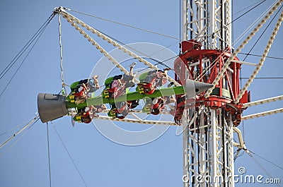 Carousel rotating and turning the people upside down Editorial Stock Photo