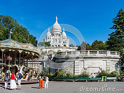 Carousel and Sacre Cour Basilica in Paris Editorial Stock Photo