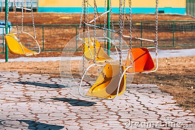 Carousels. Empty children`s attraction. Abandoned metal carousel playground. Stock Photo