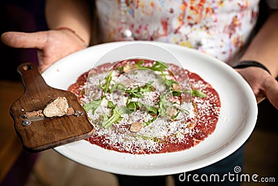 Carpaccio with parmesan, truffles and arugula on a white plate Stock Photo