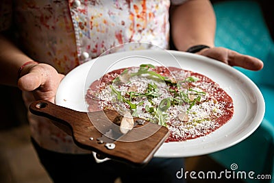 Carpaccio with parmesan, truffles and arugula on a white plate Stock Photo