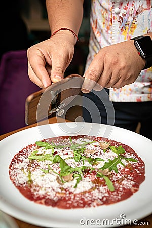 Carpaccio with parmesan, truffles and arugula on a white plate Stock Photo