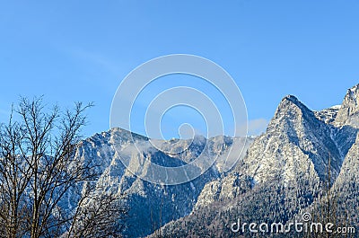 Carpathian mountains, Bucegi with Caraiman Peak, clouds, snow Stock Photo