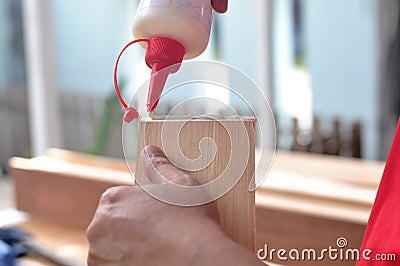 Hands of carpenter gluing the wood Stock Photo