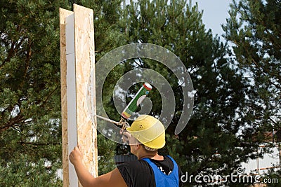 Carpenter applying wood glue to a panel Stock Photo
