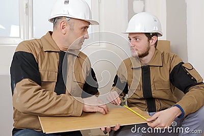 Carpenter apprentice measurement plank Stock Photo