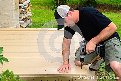 Carpenter Bulding Deck with Drill Stock Photo