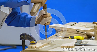 Carpenter with chisel and hammer in workshop Stock Photo