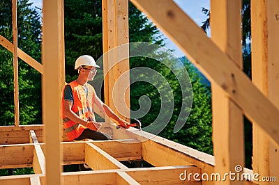 Carpenter constructing wooden frame house. Stock Photo