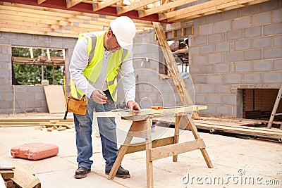 Carpenter Cutting House Roof Supports On Building Site Stock Photo