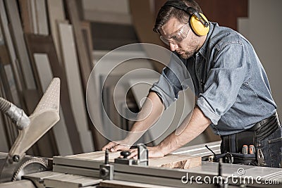 Carpenter cutting wood on workbench Stock Photo