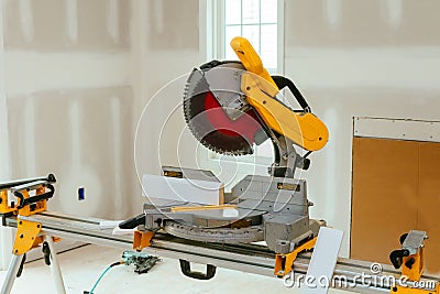 Carpenter cutting wooden plank with circular saw wearing safety Stock Photo