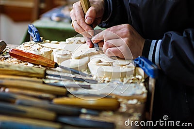 Carpenter hand carving wood with care Stock Photo