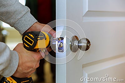 Carpenter Install Door Lock Using Screwdriver At Home Stock Photo