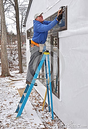 Carpenter installing windows Stock Photo