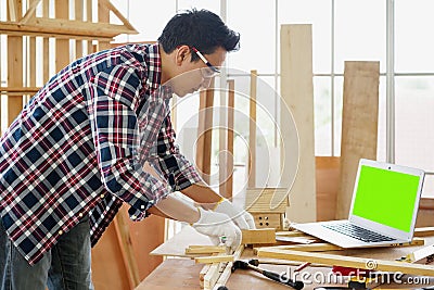 Carpenter making birdhouse. Carpenter or carpenter works in a workshop Stock Photo