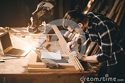 Carpenter man Wood worker working hand made furniture in shop factory industry. male wooden craftsman builder working in workshop Stock Photo