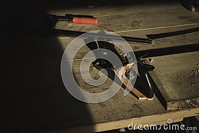 A carpenter office desk inside a small carpentry workshop showing tools for handcrafting the wood. A small wood saw and Stock Photo