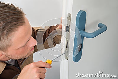 Carpenter Repairing Door Lock Stock Photo