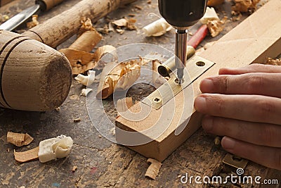 Carpenter screwed a hinge Stock Photo