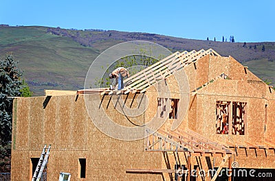 Carpenter Setting Trusses Stock Photo