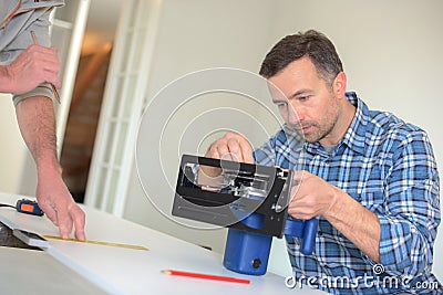 Carpenter setting up circular saw Stock Photo