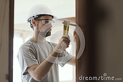 Carpenter taking measures with a folding ruler Stock Photo