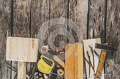 The carpenter tools on wooden bench, plane, chisel,mallet, tape measure, hammer, tongs, pliers, level, nails and a saw Stock Photo