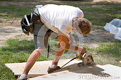 Carpenter Using Saw Stock Photo