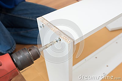 Carpenter using Screwdriver assemble furniture Stock Photo