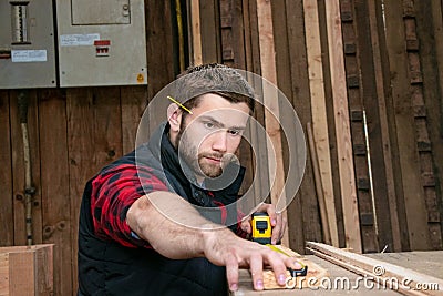 Carpenter, wood worker work measuring, drilling and making timber product Stock Photo