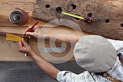 Carpenter work the wood, measuring with setsquare and pencil old Stock Photo