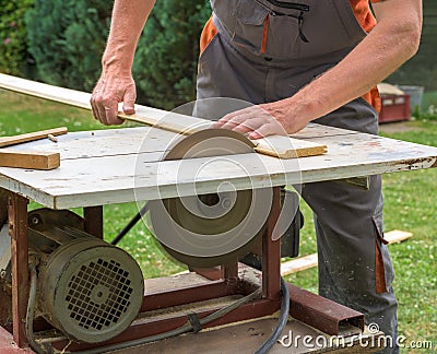 Carpenter working with electric buzz saw Stock Photo