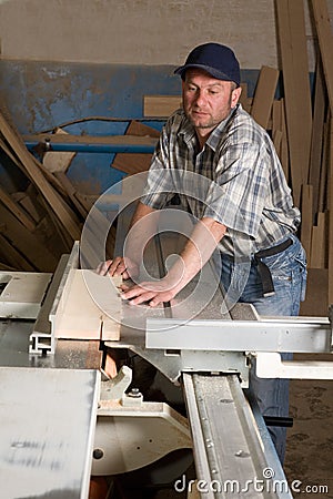 Carpenter working on woodworking machines Stock Photo