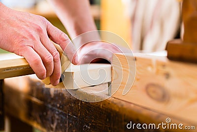 Carpenter with workpiece in carpentry Stock Photo