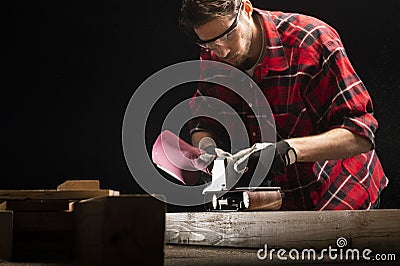 Carpenter works with electrical planer Stock Photo