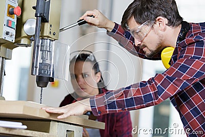 carpenters working with drill on wood Stock Photo