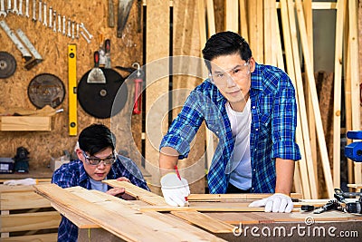 Carpenters are working in a wood factory. A carpenter or furniture maker made of wood Stock Photo