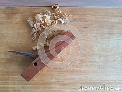 Carpentry plane on wooden plate. Stock Photo