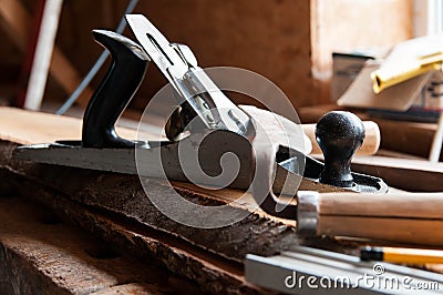 Carpentry tools on wood boards, focus on the plane Stock Photo