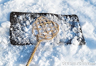 Carpet beater over carpet with snow for winter cleaning Stock Photo
