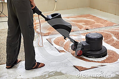 Carpet chemical cleaning with professionally disk machine. Early spring cleaning or regular clean up. Stock Photo