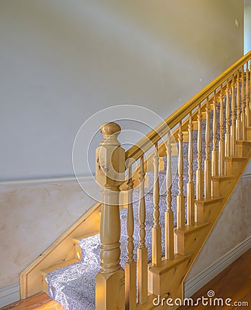 Carpet stairs with wood railing in home Stock Photo