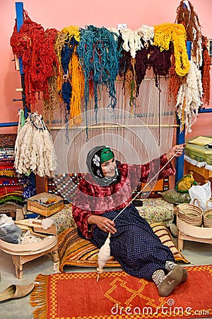 Carpet weaver, traditional vintage craftsmanship, Moroccan home business Editorial Stock Photo