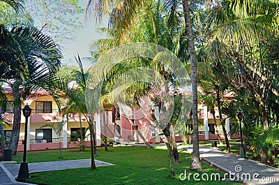Carribean resort hotel partly hidden by trees Editorial Stock Photo