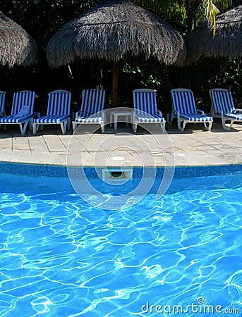 Carribean resort with poolside chairs Stock Photo